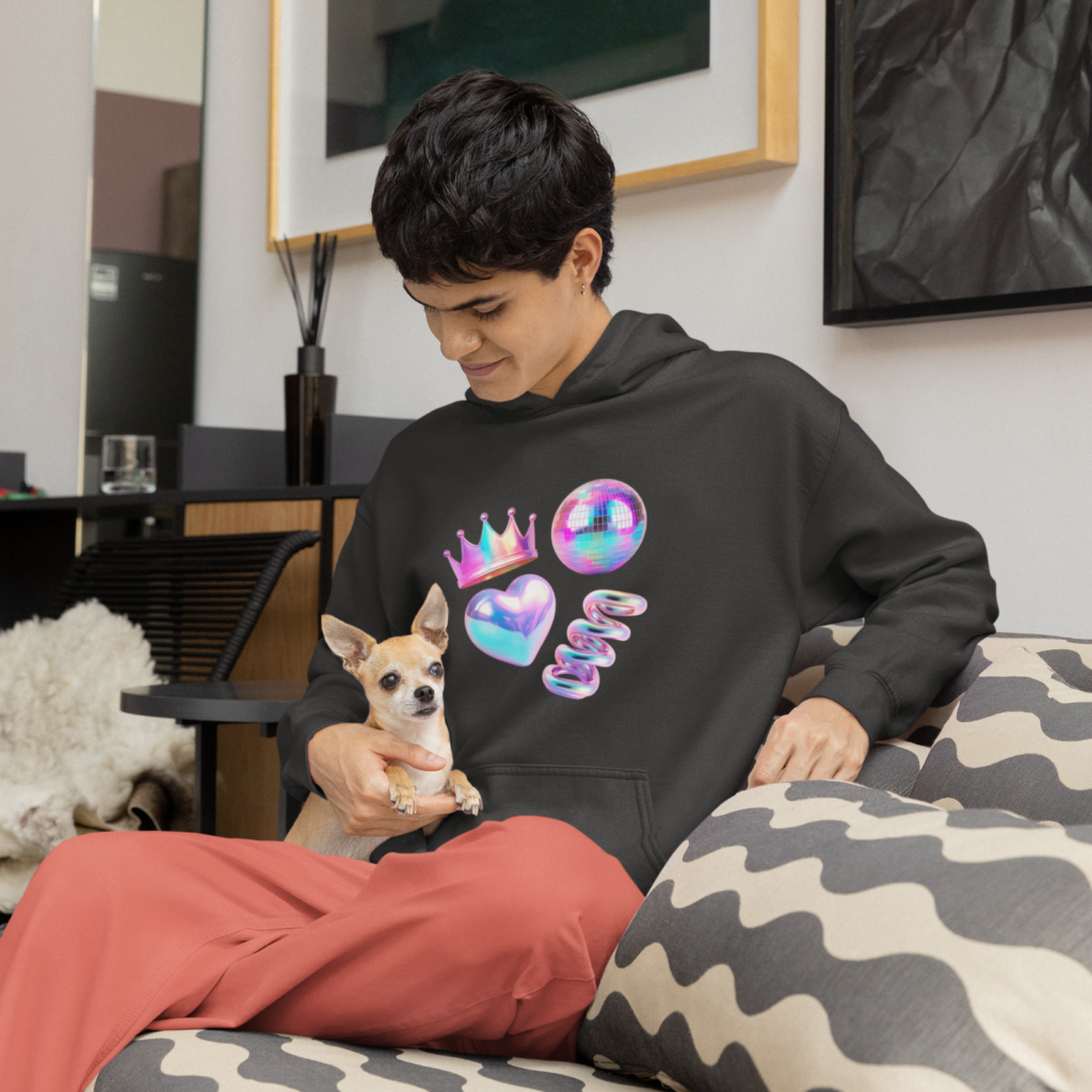 3D shapes and elements A man in a black hoodie with abstract prints, sitting on a couch with a dog on his lap.