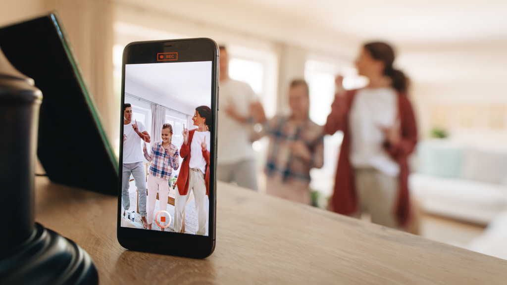Pick a niche that the algorithm can understand A smartphone on a table records a family cheerfully dancing in a bright living room.