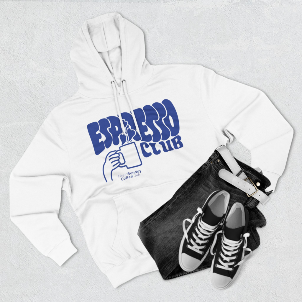 Three Panel Fleece Hoodie A custom white hoodie with an “Espresso Club” print, with a pair of jeans and shoes next to it.