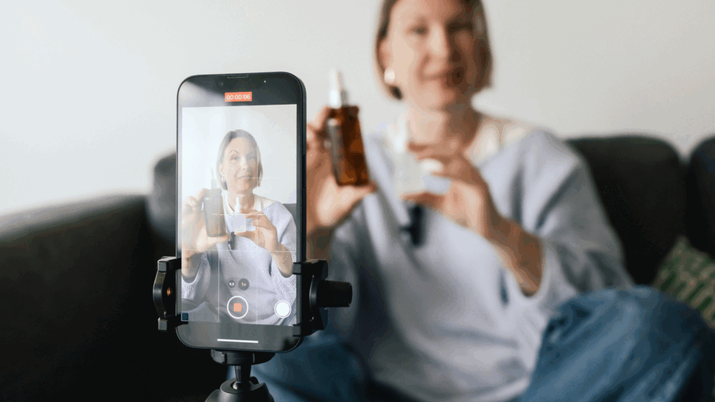 User generated content UGC A woman holds a smartphone with a video camera, preparing to record a video.