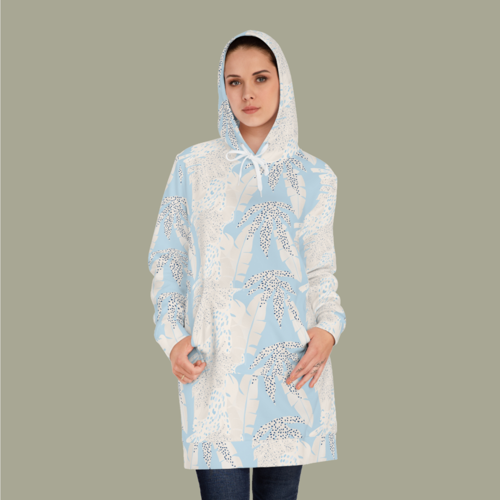 Womens hoodie dress AOP A woman in a custom white hoodie dress with an abstract floral print against a light gray background.